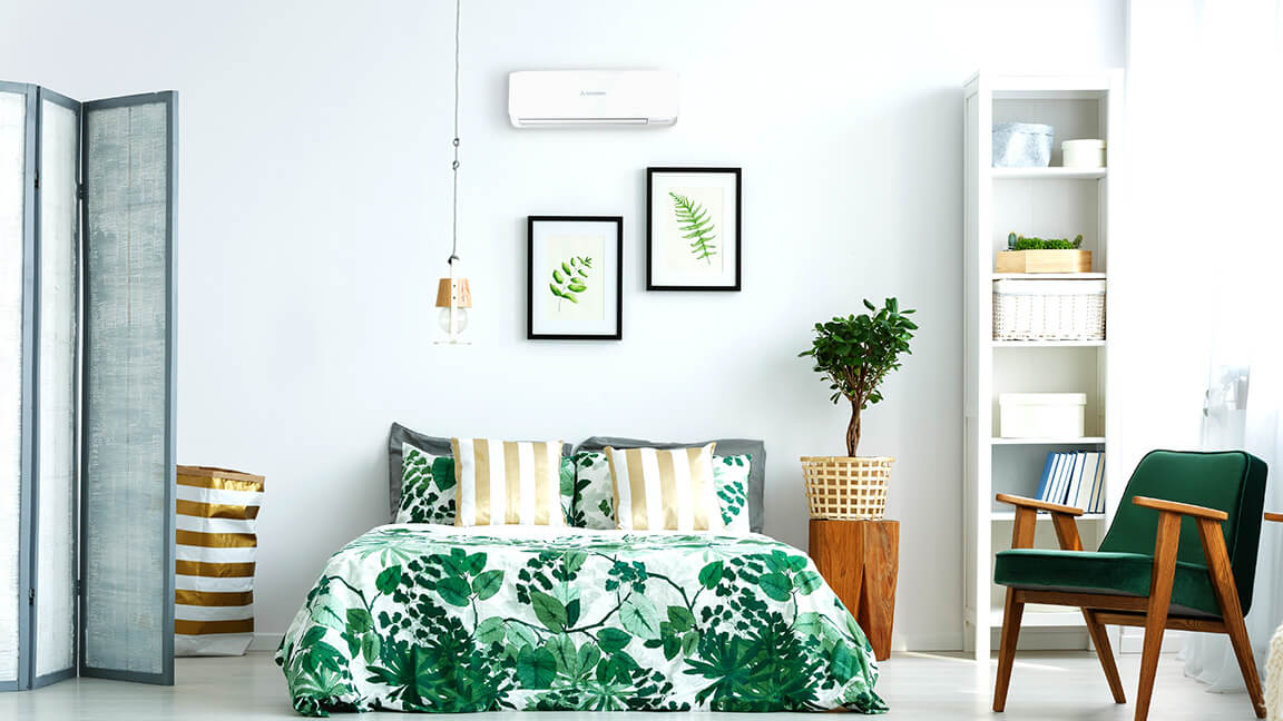white painted bedroom with greenery bed sheets